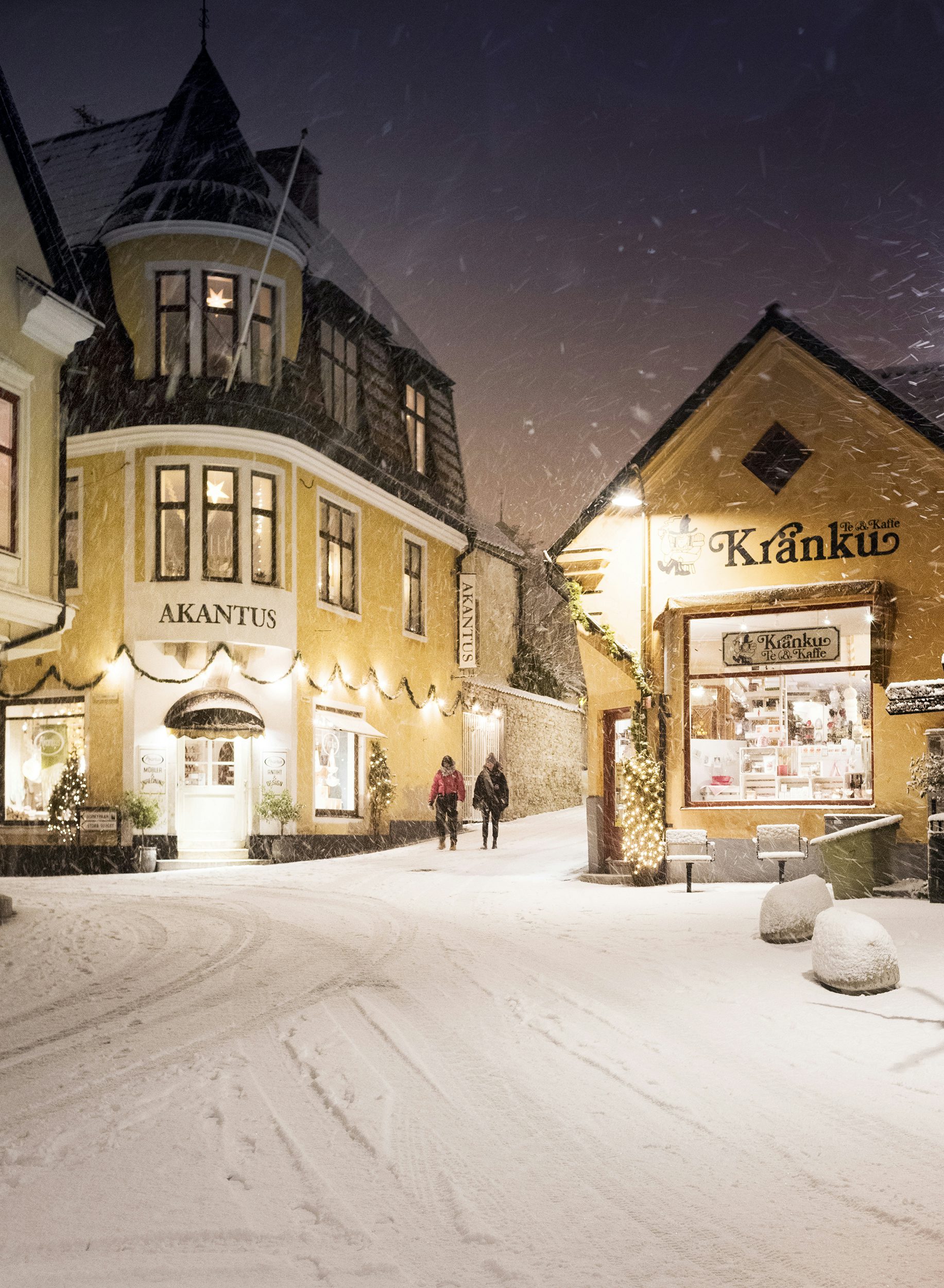 Butikerna Kränku och Akantus på S:t Hansplan i Visby en snöig kväll.